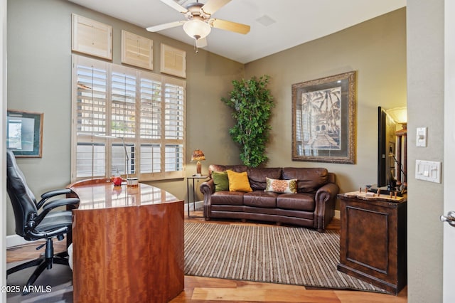 office with hardwood / wood-style flooring and ceiling fan