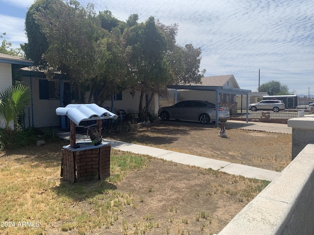 5833 W Rosewood Ln, Phoenix, AZ 85031 - view of yard featuring a carport and driveway