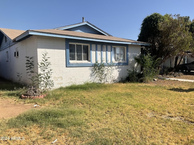 5833 W Rosewood Ln, Phoenix, AZ 85031 - view of side of property featuring a lawn