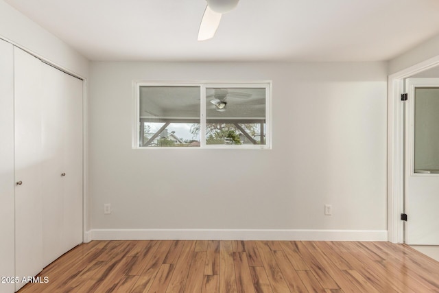 unfurnished bedroom featuring a closet, baseboards, and wood finished floors