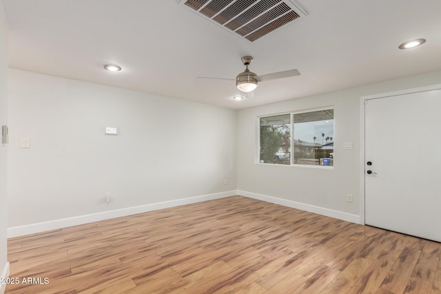 interior space with light wood finished floors, baseboards, visible vents, and a ceiling fan