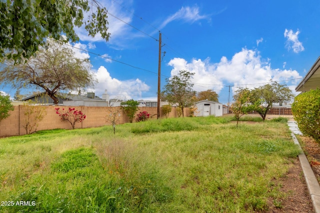 view of yard with an outdoor structure and a fenced backyard