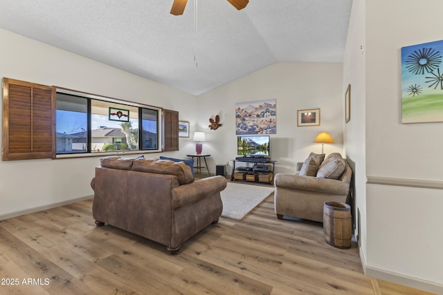 living room featuring ceiling fan, vaulted ceiling, hardwood / wood-style floors, and a textured ceiling