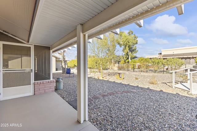 view of patio / terrace featuring a sunroom