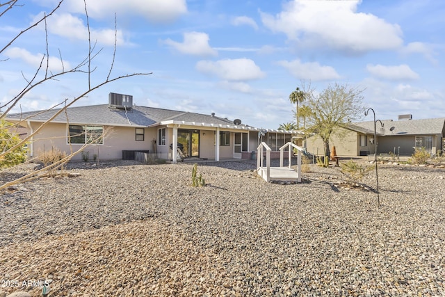 rear view of house featuring central AC unit