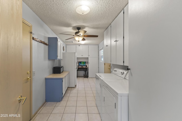 kitchen with white cabinetry, washer and clothes dryer, light tile patterned floors, ceiling fan, and a textured ceiling