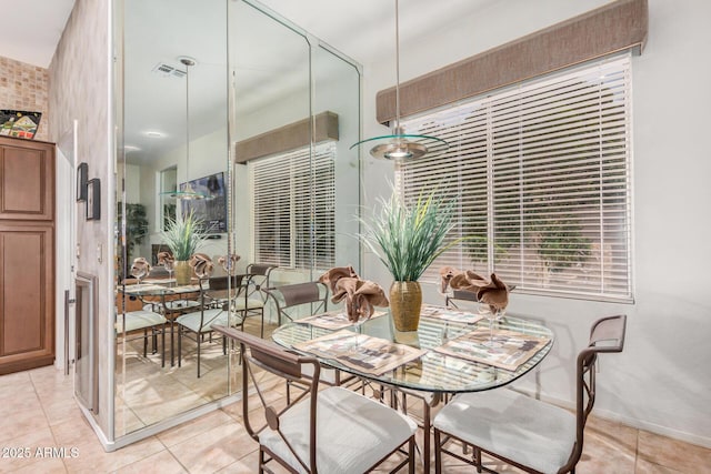 dining room with light tile patterned floors and visible vents