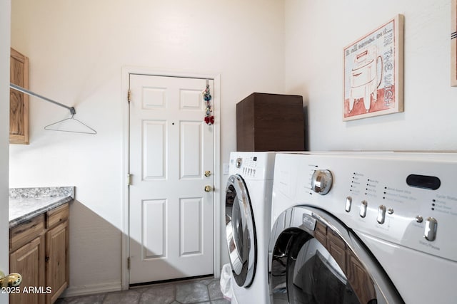 laundry room with washer and clothes dryer and cabinets