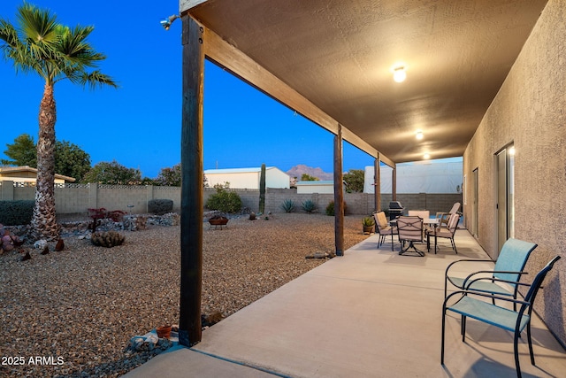 view of patio terrace at dusk