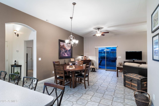 dining space with ceiling fan with notable chandelier