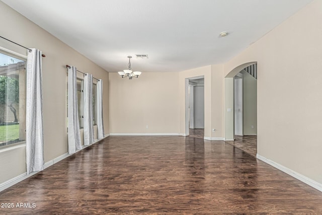 4507 E Lantern Pl, Gilbert, AZ 85297 - empty room with arched walkways, wood finished floors, a chandelier, and baseboards