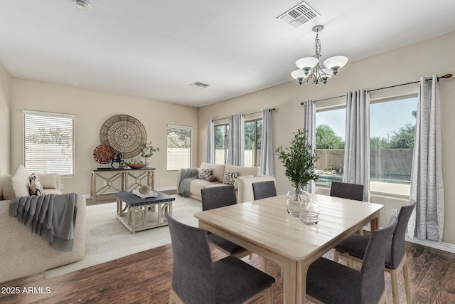 4507 E Lantern Pl, Gilbert, AZ 85297 - dining room with a chandelier, dark wood-type flooring, healthy amount of natural light, and baseboards