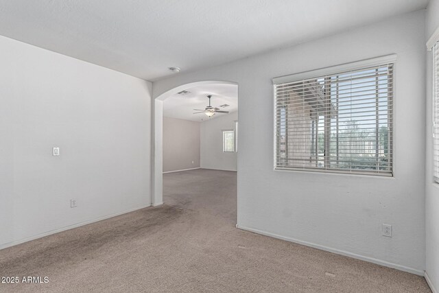4507 E Lantern Pl, Gilbert, AZ 85297 - empty room with carpet floors, ceiling fan, arched walkways, and baseboards