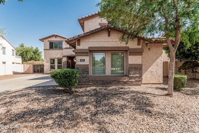4507 E Lantern Pl, Gilbert, AZ 85297 - view of front of house with stucco siding, a tile roof, concrete driveway, and stone siding