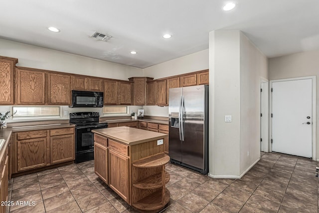 4507 E Lantern Pl, Gilbert, AZ 85297 - kitchen featuring black appliances, a center island, open shelves, recessed lighting, and brown cabinets