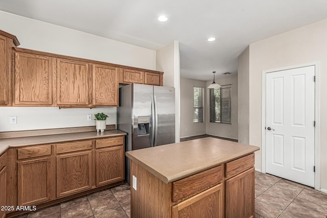 4507 E Lantern Pl, Gilbert, AZ 85297 - kitchen featuring stainless steel fridge with ice dispenser, recessed lighting, brown cabinetry, a kitchen island, and tile patterned floors