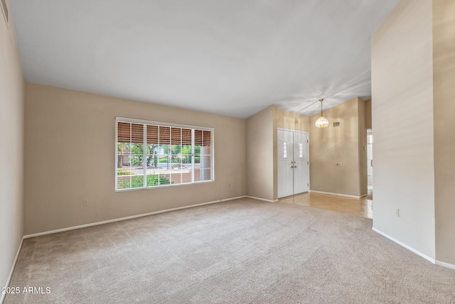 carpeted empty room featuring baseboards