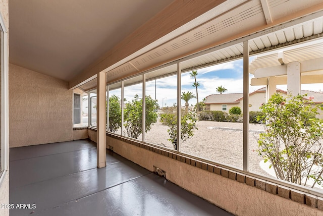 unfurnished sunroom featuring finished concrete floors