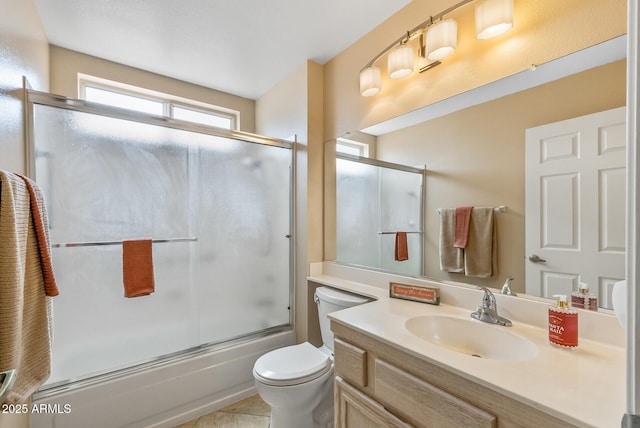 full bath with enclosed tub / shower combo, toilet, and vanity