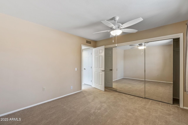 unfurnished bedroom featuring ceiling fan, baseboards, visible vents, and carpet
