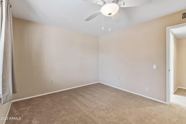unfurnished room featuring visible vents, carpet flooring, baseboards, and a ceiling fan