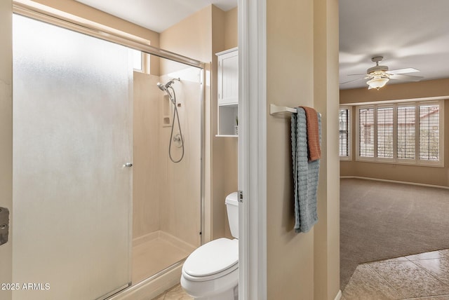 bathroom with a shower stall, ceiling fan, and plenty of natural light