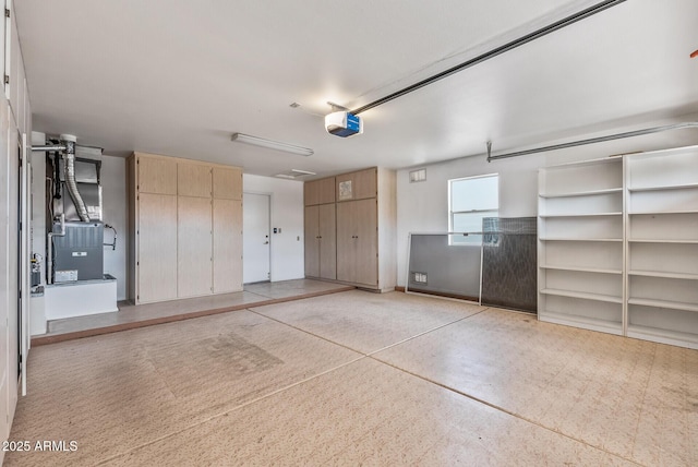 garage with a garage door opener, heating unit, and baseboards