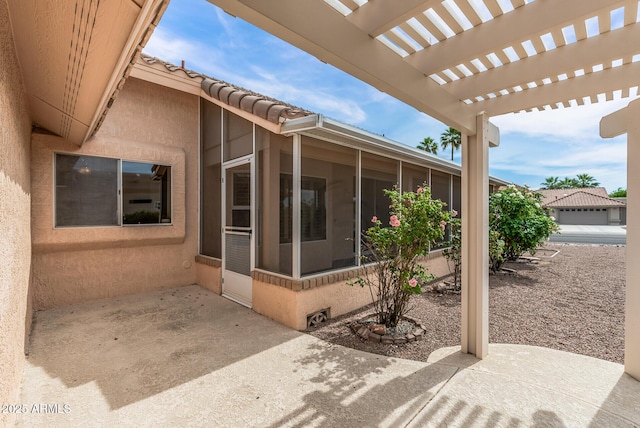 view of patio with a pergola and a sunroom