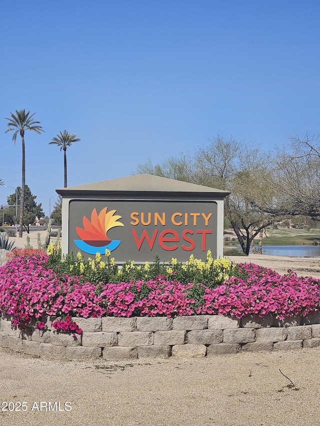 community / neighborhood sign with a water view