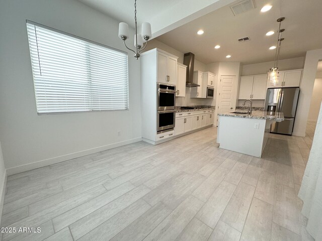 5923 N 85th Ave, Glendale, AZ 85305 - kitchen with wall chimney range hood, appliances with stainless steel finishes, a sink, and visible vents