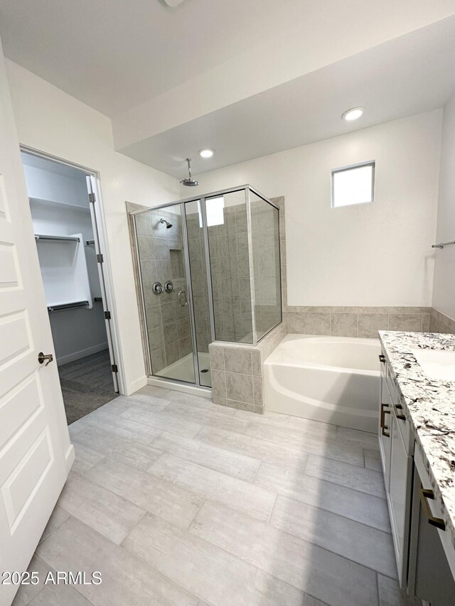 5923 N 85th Ave, Glendale, AZ 85305 - bathroom with vanity, recessed lighting, a garden tub, and a shower stall