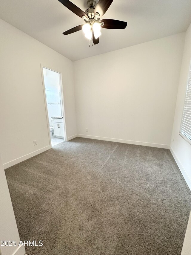 5923 N 85th Ave, Glendale, AZ 85305 - spare room with a ceiling fan, baseboards, and dark colored carpet