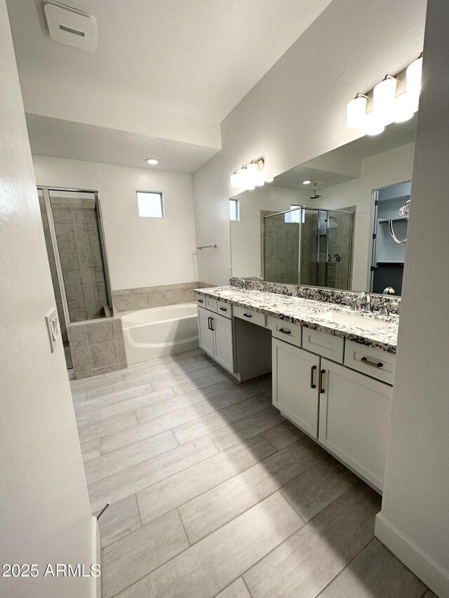 5923 N 85th Ave, Glendale, AZ 85305 - bathroom featuring vanity, a stall shower, and a bath