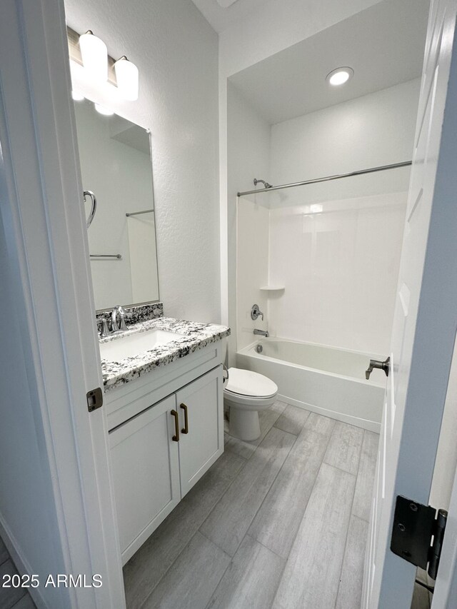 5923 N 85th Ave, Glendale, AZ 85305 - full bathroom with washtub / shower combination, vanity, toilet, and wood finished floors