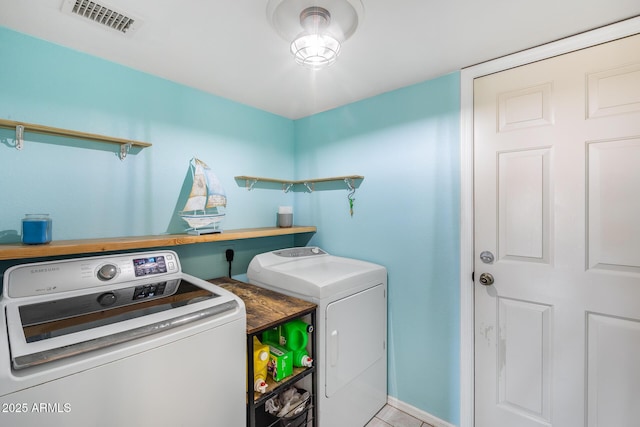 laundry area featuring laundry area, washing machine and dryer, and visible vents