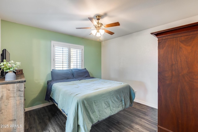 bedroom featuring ceiling fan, dark wood finished floors, and baseboards