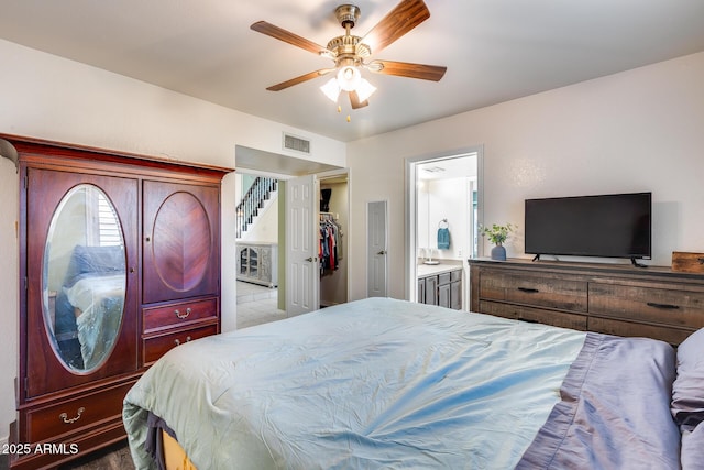 bedroom with ensuite bath, visible vents, and ceiling fan