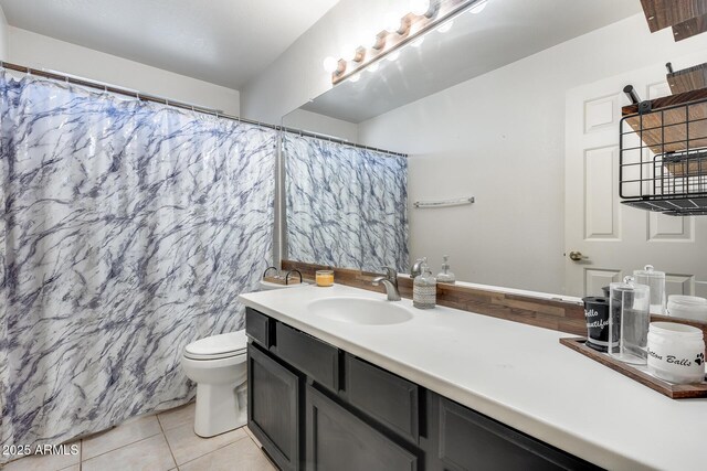 bathroom with toilet, vanity, a shower with shower curtain, and tile patterned floors