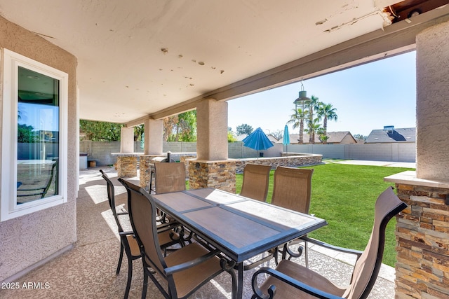 view of patio with outdoor dining space and a fenced backyard