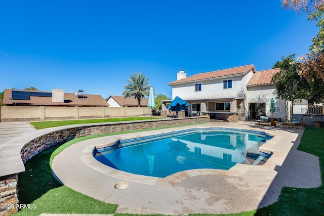 view of swimming pool with a fenced in pool, fence, and a patio