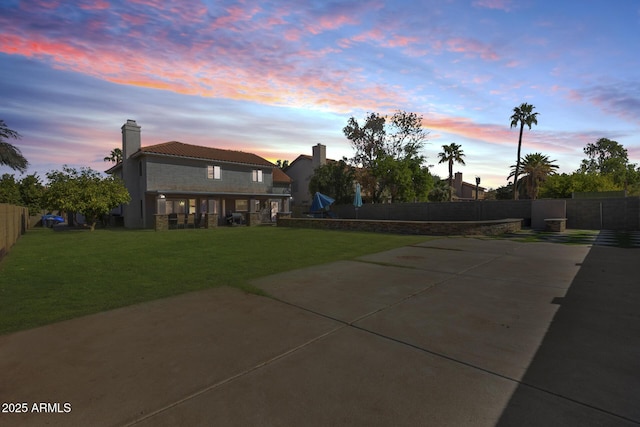 exterior space with a yard, a chimney, and fence