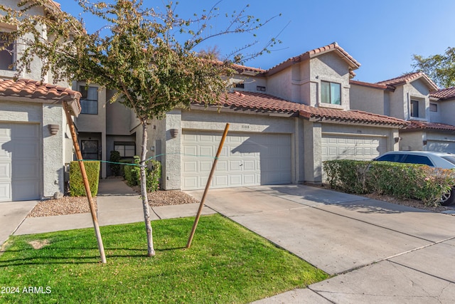 view of front of home featuring a garage and a front lawn