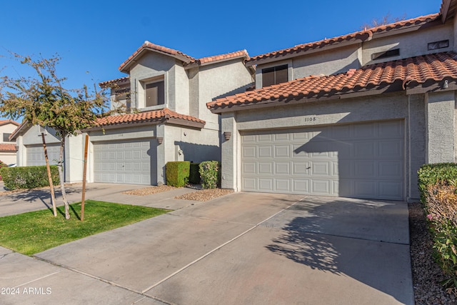 mediterranean / spanish house with a garage