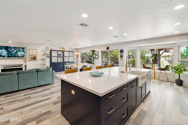 1656 W Meseto Cir, Mesa, AZ 85202 - kitchen with a sink, open floor plan, light countertops, recessed lighting, and a kitchen island with sink