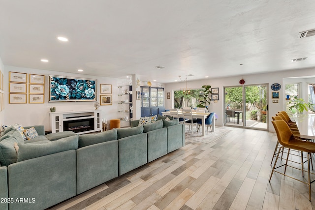 1656 W Meseto Cir, Mesa, AZ 85202 - living area featuring light wood-style floors, recessed lighting, and a glass covered fireplace