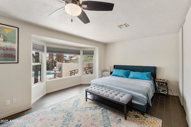1656 W Meseto Cir, Mesa, AZ 85202 - bedroom with wood finished floors, a textured ceiling, baseboards, and a ceiling fan
