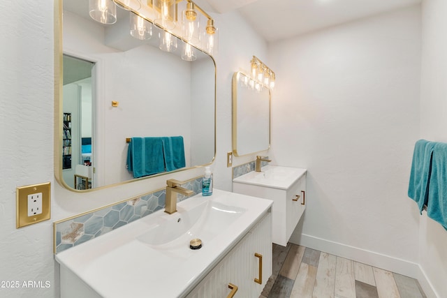 1656 W Meseto Cir, Mesa, AZ 85202 - bathroom featuring two vanities, wood finished floors, and baseboards