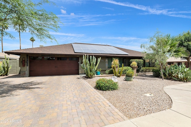 1656 W Meseto Cir, Mesa, AZ 85202 - ranch-style home with decorative driveway, an attached garage, solar panels, and roof with shingles