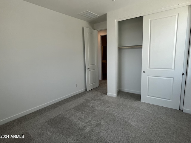 unfurnished bedroom with carpet floors and a closet