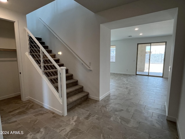 stairs featuring tile patterned floors